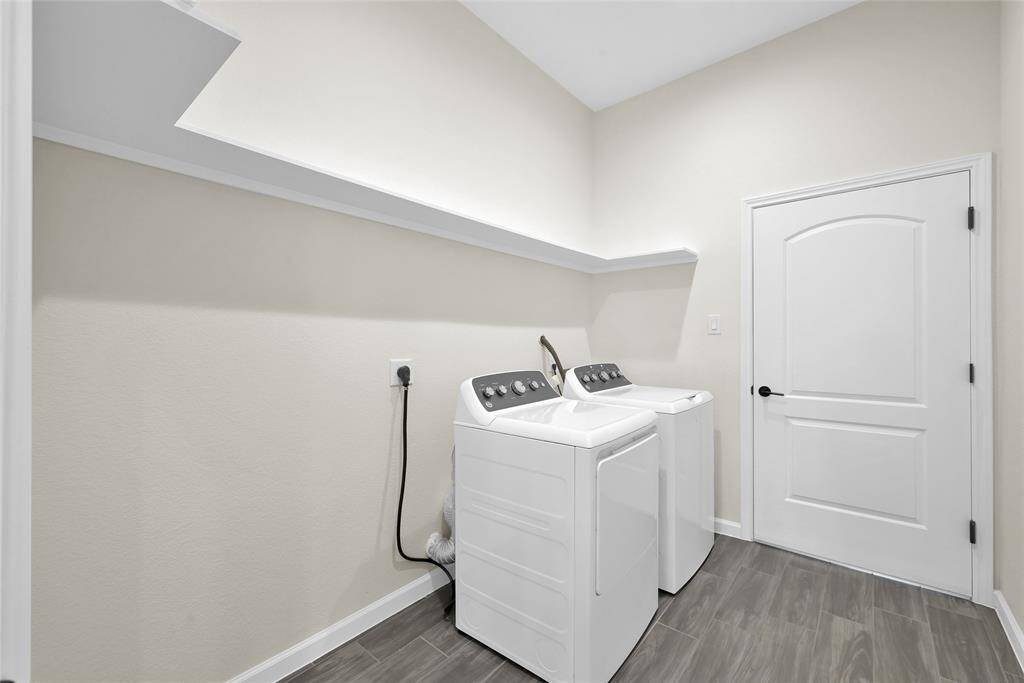 Laundry room connects the garage to the main living area and is conveniently located near the primary bedroom for everyday ease