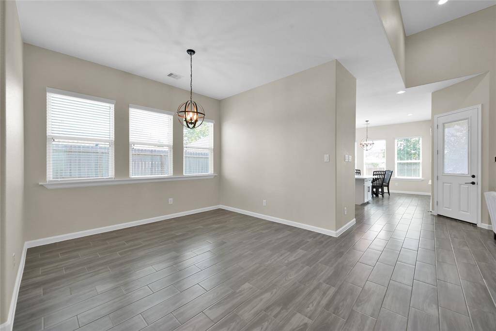 Elegant formal dining room with large windows and space to host family gatherings.