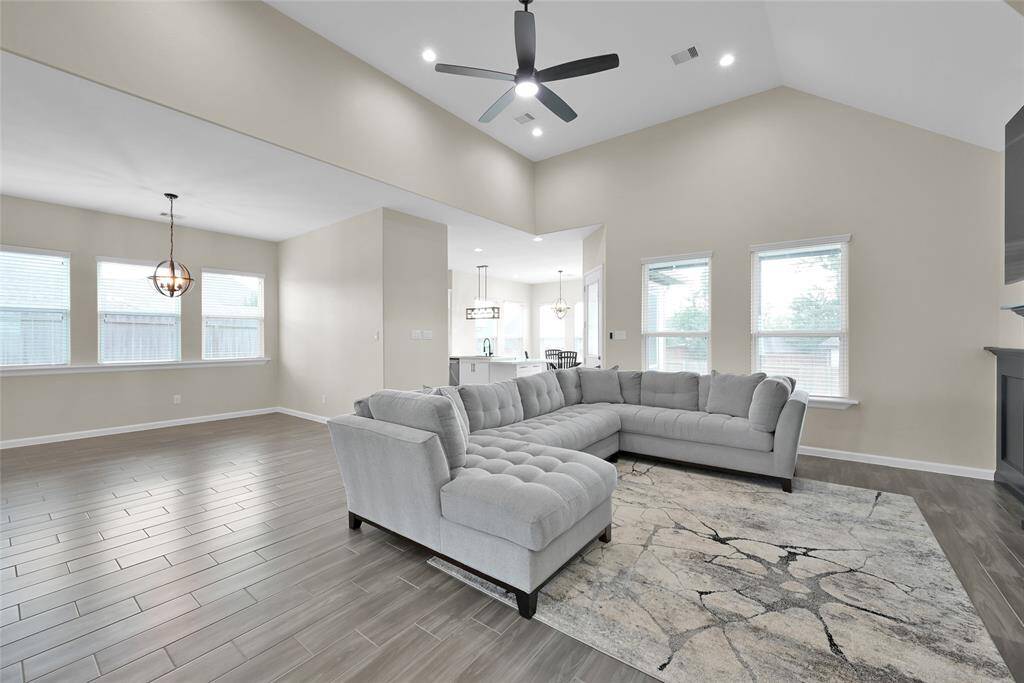 Living room flows seamlessly into the kitchen and dining areas, creating an ideal space for everyday living and entertaining