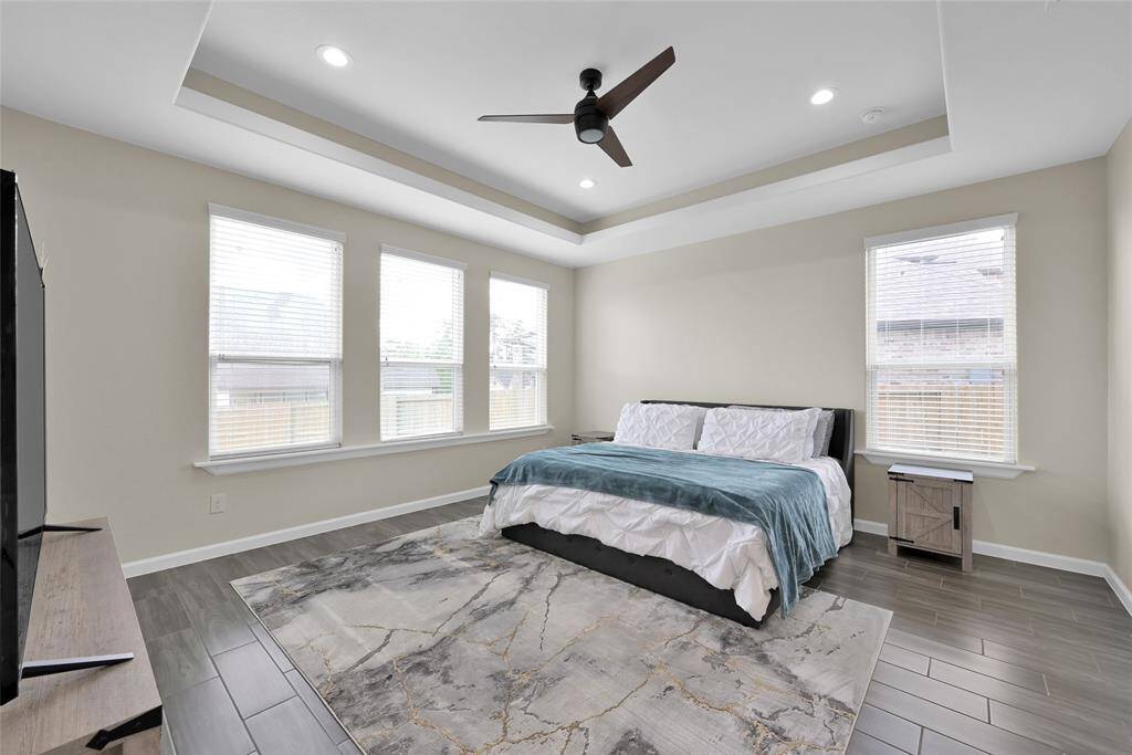 Generously sized primary suite with high ceilings and a serene atmosphere