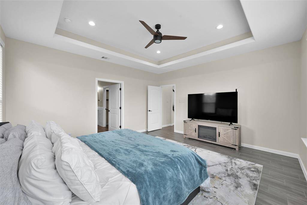 Generously sized primary suite with high ceilings and a serene atmosphere