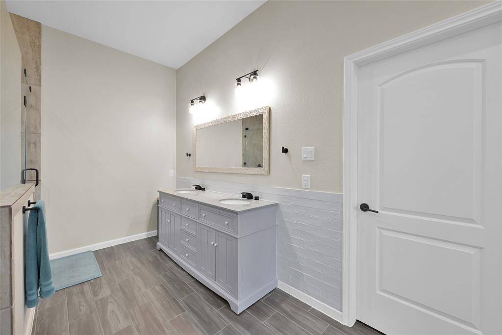 Private bath with dual sinks, soaking tub, separate shower, and lots of natural light.