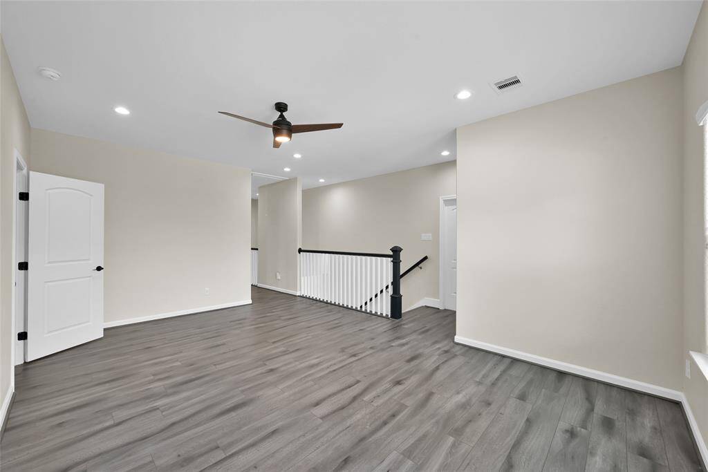 Versatile upstairs game room offering extra space for entertainment, hobbies, or a home office.