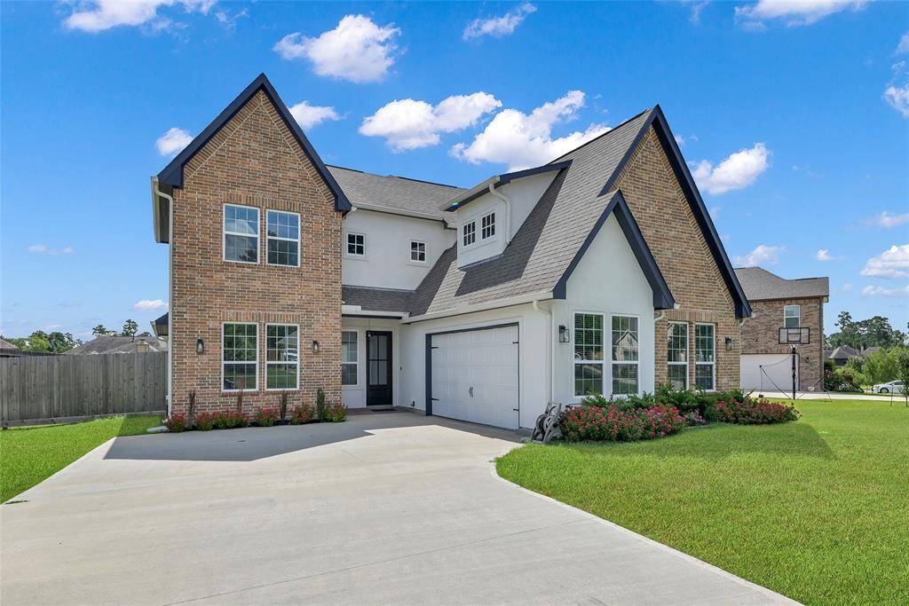 Spacious driveway offers room for multiple vehicles, whether for entertaining or everyday projects.