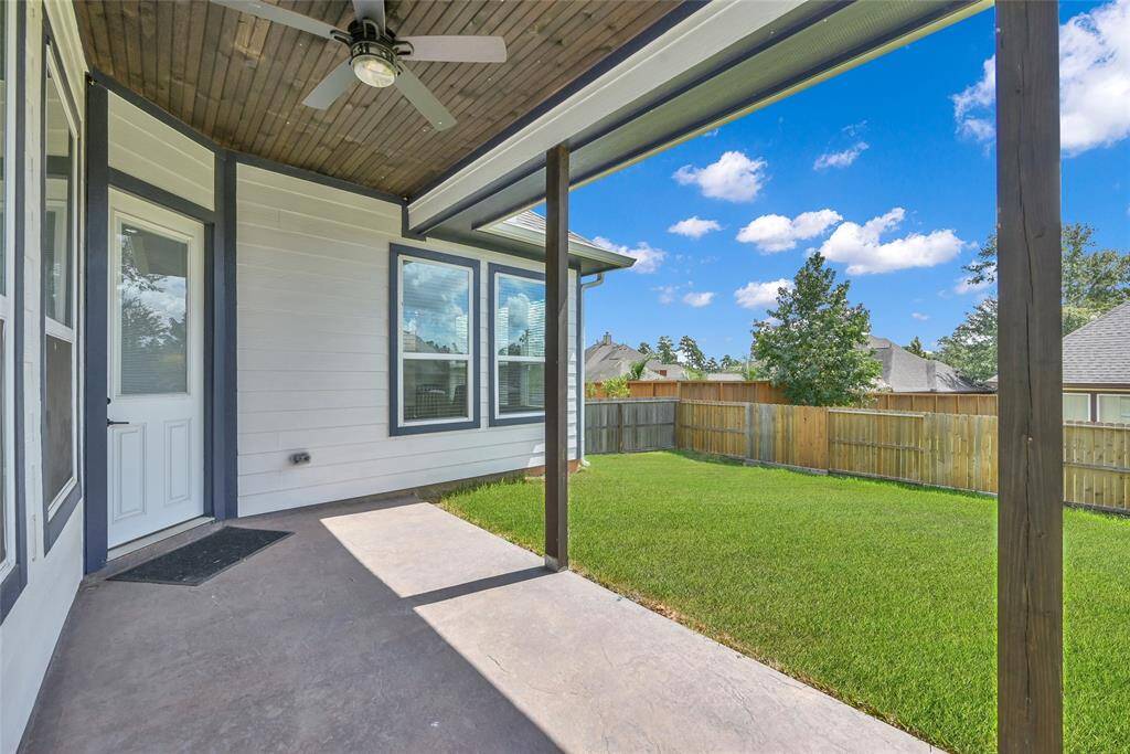 Covered back patio provides convenient shade from the Houston sun while overlooking the backyard
