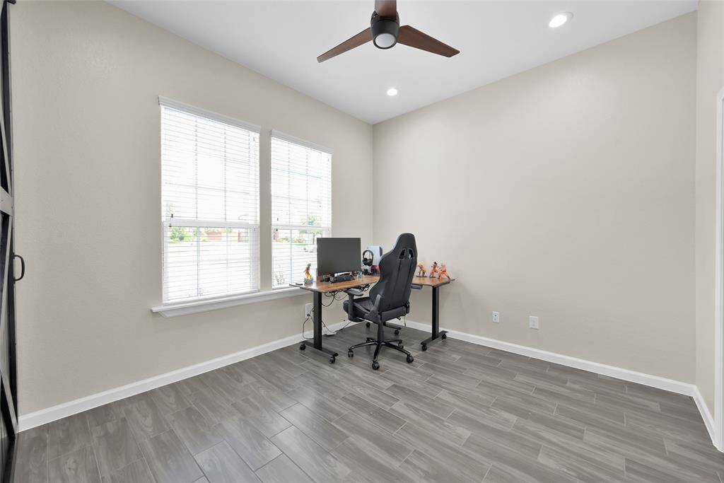Versatile main-level office features an en-suite full bath, offering the option to serve as an additional bedroom.