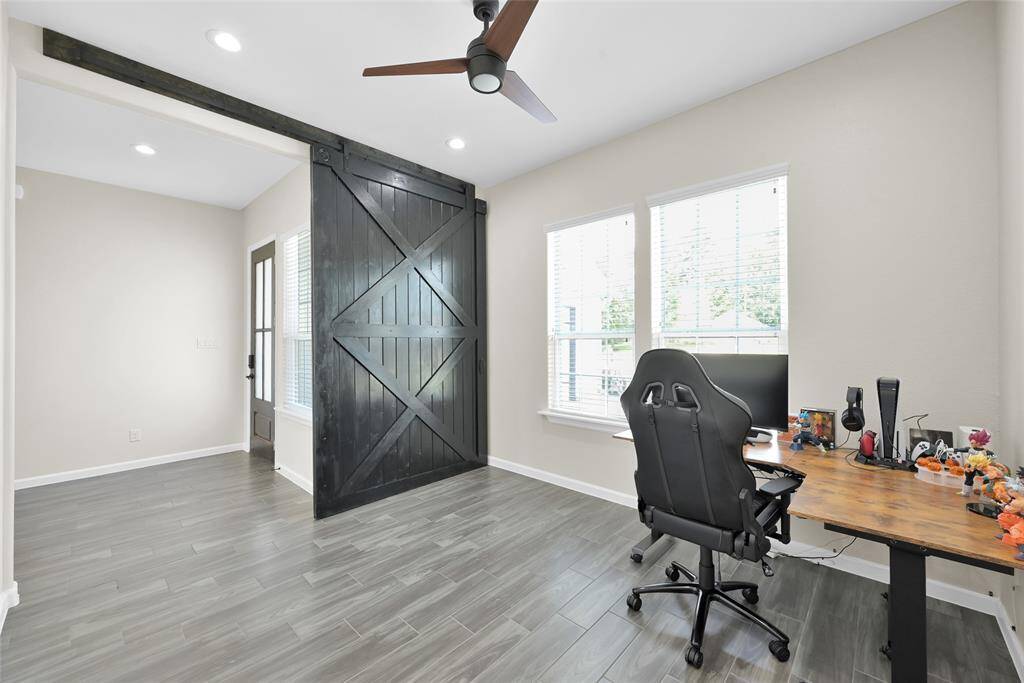 Versatile main-level office features an en-suite full bath, offering the option to serve as an additional bedroom