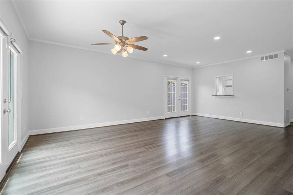 The spacious living room is filled with an abundance of natural light, all new LED lighting & ceiling fan.
