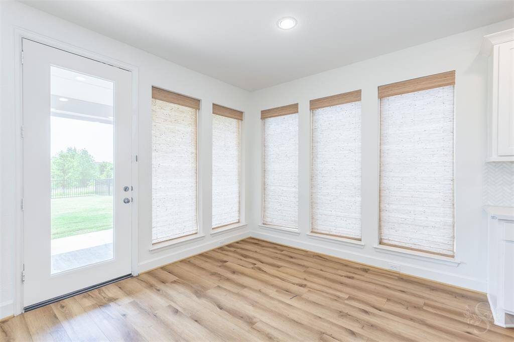 Enjoy morning coffee in the bright breakfast room, wrapped in windows that fill the space with natural light. A door leads to the backyard, blending indoor comfort with outdoor charm.