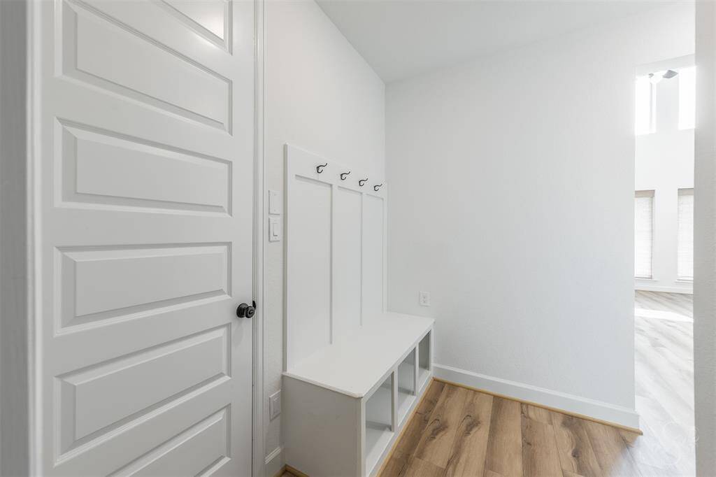 Located just off the garage, the built-in mud area with bench offers the perfect drop zone for bags, shoes, and jackets. Clean lines and open cubbies keep everything organized in style.