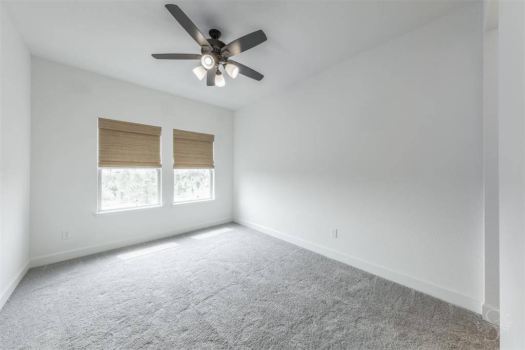 This secondary bedroom provides the space you need for a large bed and any additional furnishings including student desks and bookcases. Featuring plush carpet, high ceiling and windows with shades.