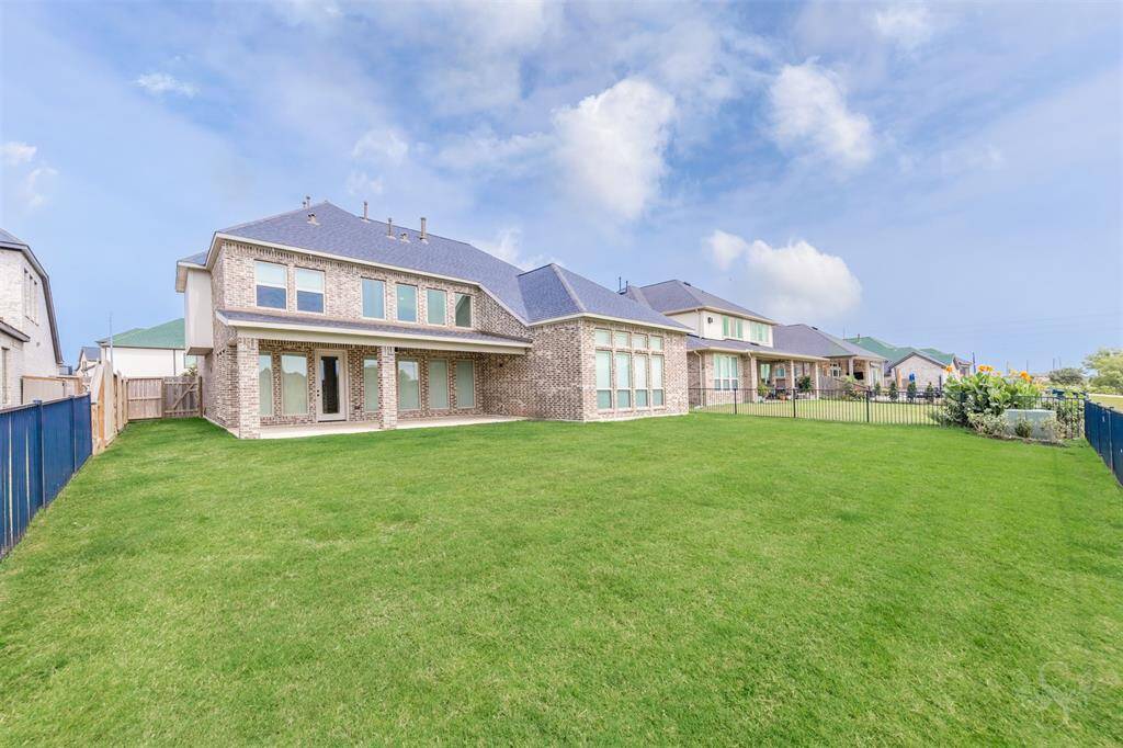 Expansive backyard offers a seamless extension of your living space, with a large covered patio that’s perfect for hosting gatherings or relaxing outdoors. Ample green space provides endless possibilities for outdoor dining, play, and entertaining.