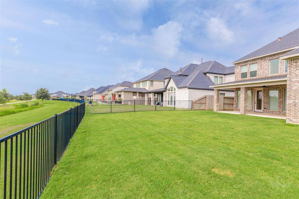 A sweeping view of the adjacent greenbelt ensures tranquility and open skies with no back neighbors in sight. Step out from your yard onto walking trails that wind through the lush community landscape.