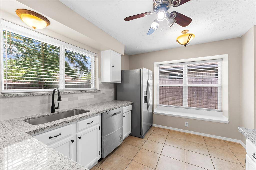 Chefs Kitchen with new appliances, granite countertops, and freshly painted sleek white cabinets.
