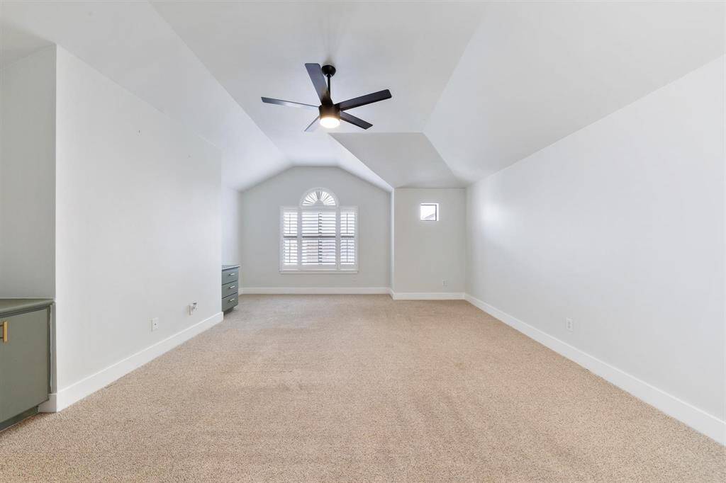 Third-floor primary bedroom offering added privacy, with ample space, soft neutral tones, and easy access to the en-suite bath
