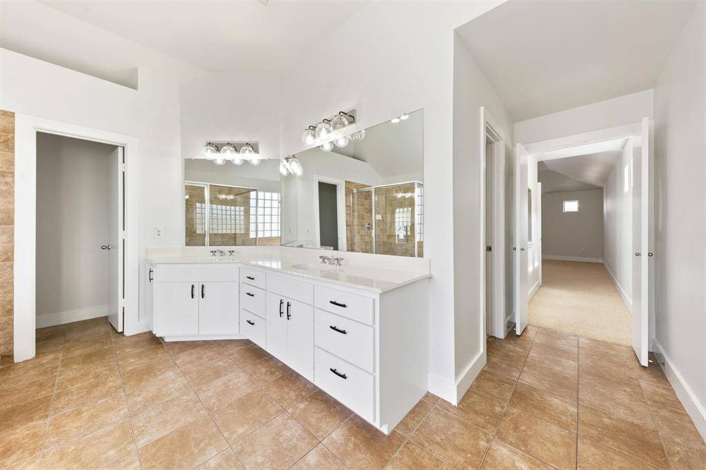 Dual vanity with plenty of cabinet space, combining functionality and style for a well-organized bathroom.