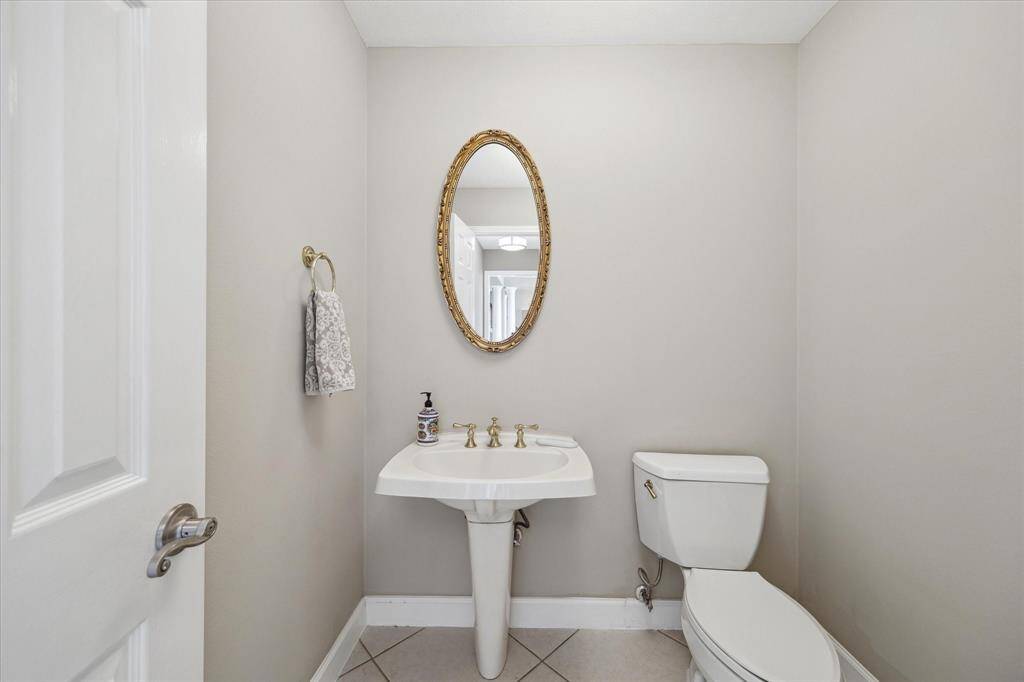 A conveniently located half bath offers comfort and privacy for guests, perfectly positioned for easy access from the main living areas.