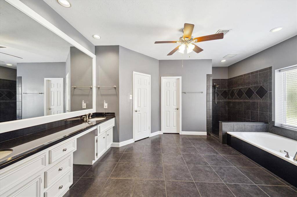 Another view of the spacious, spa-like primary bath—designed for relaxation with luxurious finishes and a serene atmosphere.