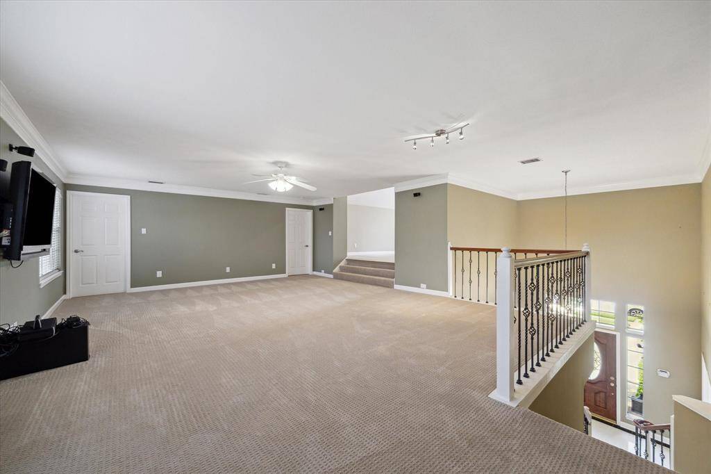 Expansive upstairs game room, perfect for entertainment and relaxation.