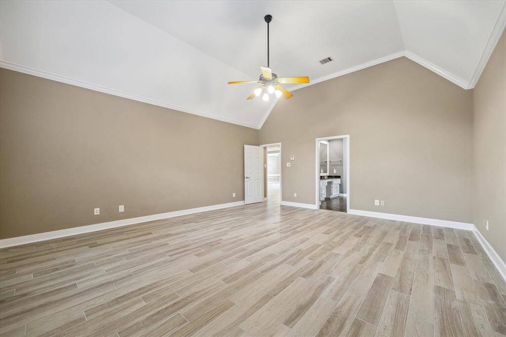 The spacious and elegant primary suite is located on the main floor.