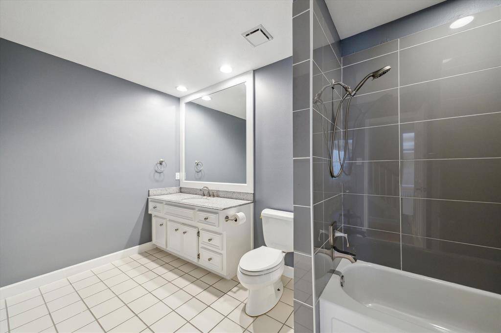 This updated bathroom offers convenient access to the fourth bedroom and game room.