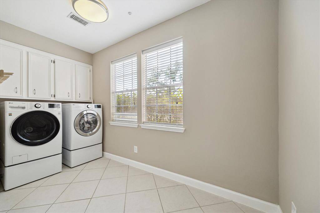 Spacious laundry room with ample space for an additional refrigerator.
