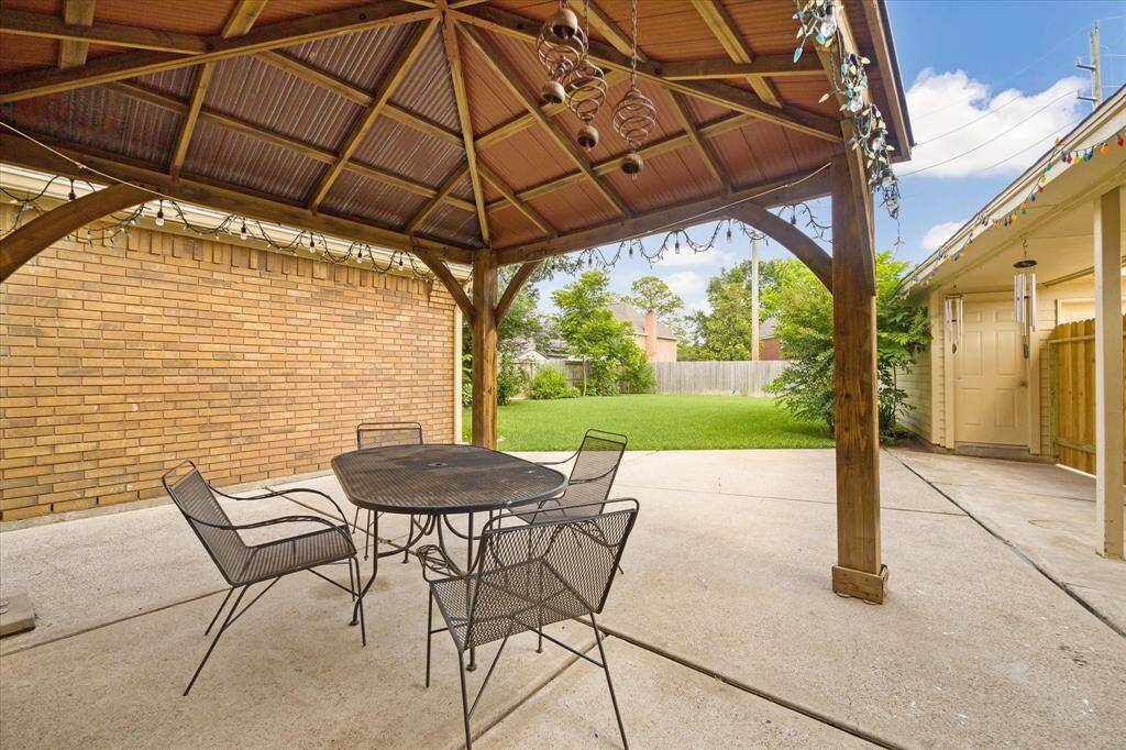 Experience ultimate relaxation in a charming backyard with a shade, perfect for summer days.