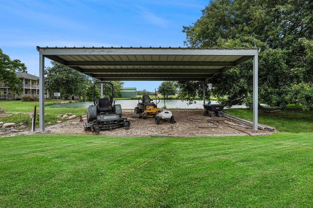 This 2-car carport is located at the back of the property near the pond, would also work well for a covered party area.
