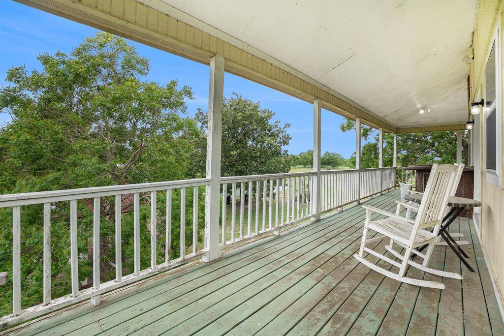 Second story wrap around porch looking out over the pond.