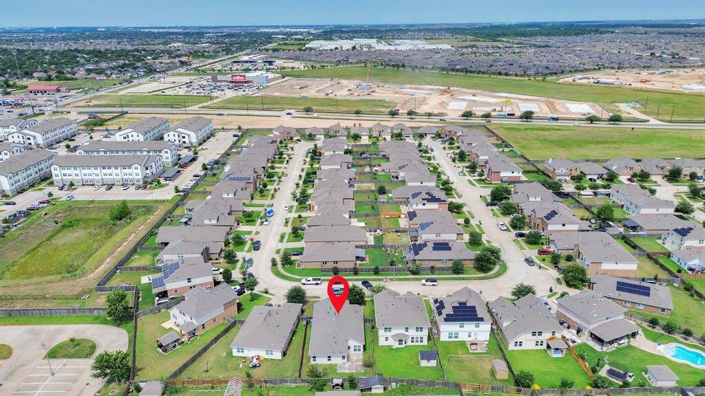 A suburban neighborhood with well-maintained homes and lush greenery. The highlighted house is centrally located, offering easy access to nearby amenities and a peaceful residential atmosphere.