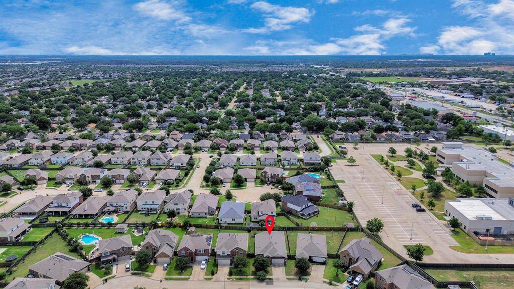 This area is organized with clear streets and nearby multi-unit buildings, offering a mix of residential options. The landscape includes open spaces, and a marked point highlights one specific property.