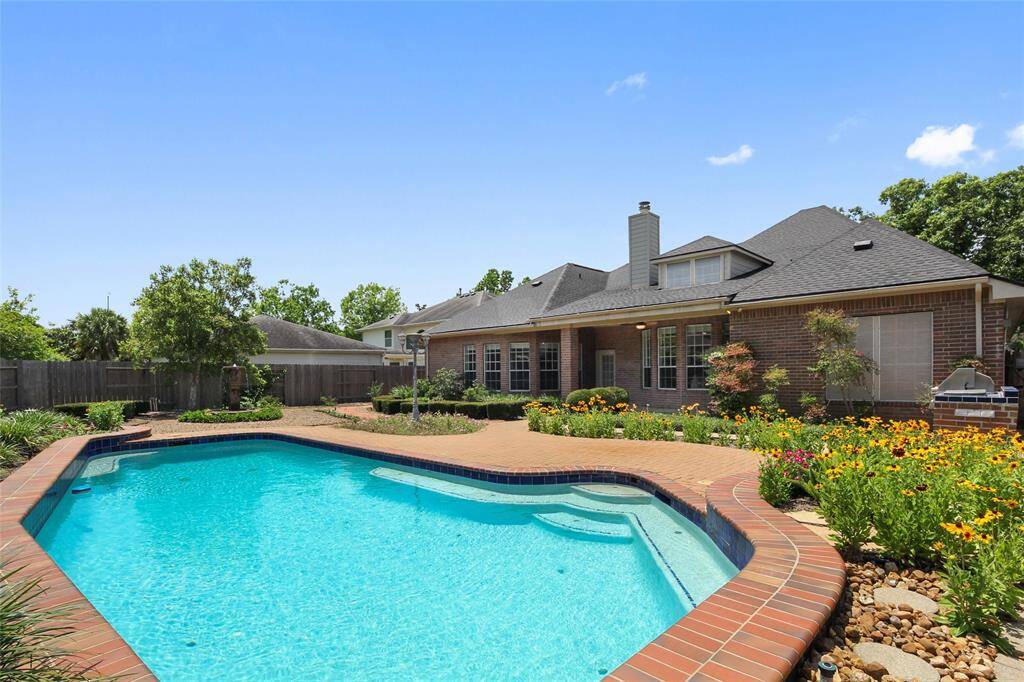 Vacation 365 days a year in back yard oasis with pool, outdoor kitchen and fountain with large yard.