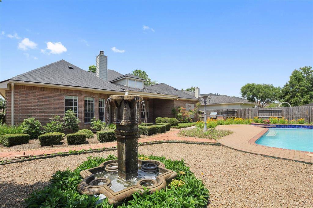 Back yard oasis with fountain, outdoor cooking and pool.
