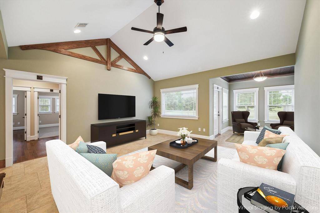 WELCOME INTO THIS SPACIOUS FAMILY ROOM THAT FLOWS EFFORTLESSLY INTO AN OPEN FLOORPLAN. HIGH CEILINGS ADORNED WITH ARCHITECTURAL WOOD DETAILING. A WALL OF WINDOWS FLOOD THE ROOM WITH LIGHT AND CUSTOM-LAID CERAMIC TILE KEEPS THE HOME COOL, CLEAN AND REFRESHING