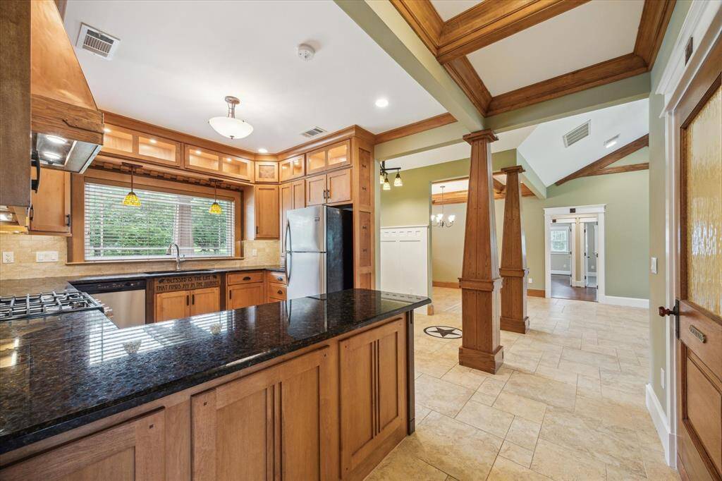 GRANITE ISLAND IS A CHEF'S DREAM! GORGEOUS POWDER ROOM IS TO THE RIGHT- NOTICE THE GORGEOUS CUSTOM WOOD DOOR!