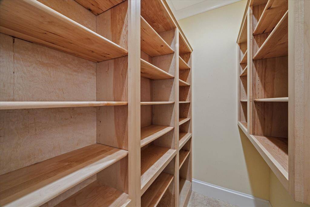 YOU'VE LIKELY NEVER SEEN A PANTRY LIKE THIS! A TRUE WALK-IN, THOUGHTFULLY DESIGNED PANTRY OFFERS CUSTOM SHELVING. THIS BEAUTIFULLY ORGANIZED EXTENSION OF THE KITCHEN IS BUILT FOR FUNCTION AND STYLE