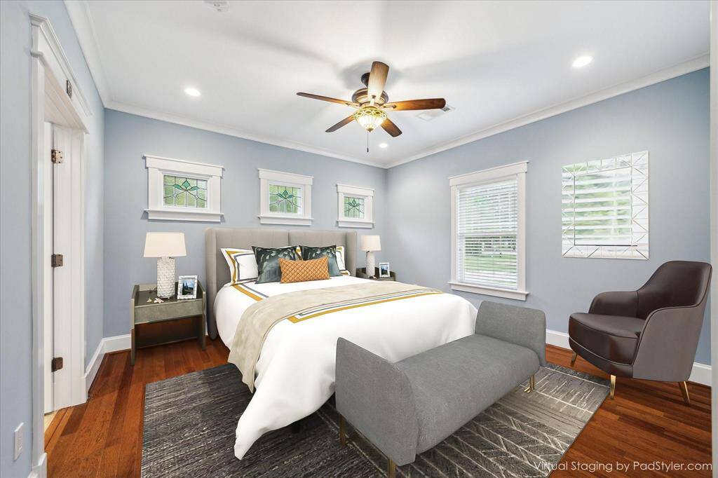 LUXURIOUS PRIMARY SUITE OFFERS CROWN MOLDING , BEAUTIFUL STAINED GLASS WINDOWS AND WELCOMES LARGE  FURNITURE