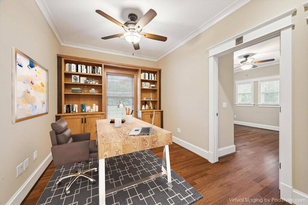 A WALL OF BEAUTIFULLY CRAFTED BURIL-IN BOOKSHELVES AND CABINETS CENTERED AROUND A CHARMING WINDOW BENCH. RICHLY FINISHED WITH CROWN MOLDING, AND WOOD FLOORING THROUGHOUT OFFICE AND SECONDARY BEDROOMS