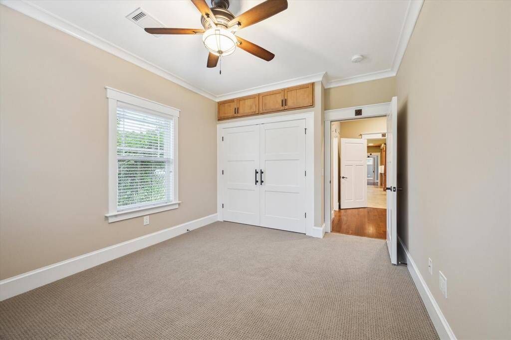 CUSTOM CLOSET WITH ADDITIONAL STORAGE ABOVE. BOTH SECONDARY BEDROOMS ARE ENTERED THROUGH THE LIBRARY