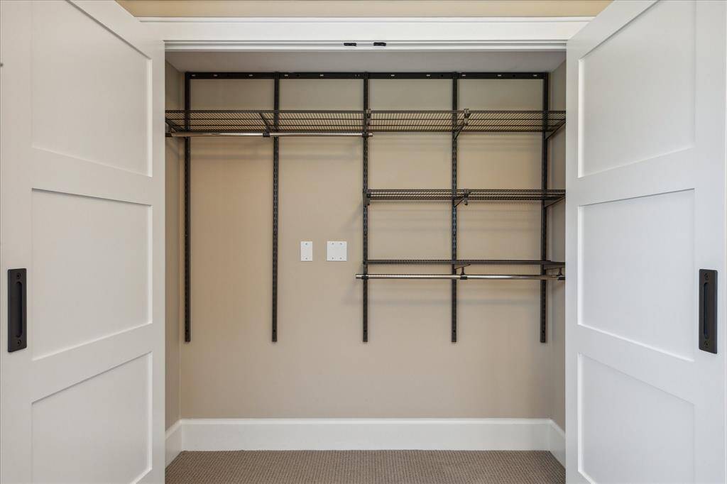 CUSTOM CLOSETS IN BOTH SECONDARY BEDROOMS COVERED BY CUSTOM DOORS- ORGANIZATION AT ITS FINEST!