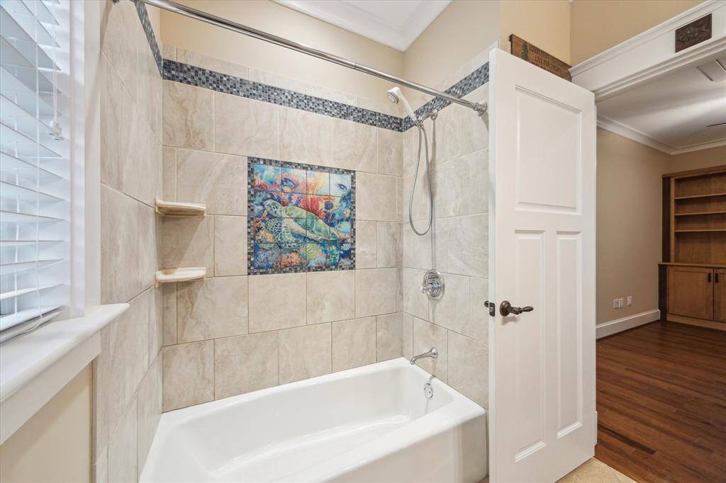 THIS BATHTUB FEATURES A HAND-LAID, ORIGINAL GLASS TILES THAT SHOWCASE A BREATHTAKING TURTLE MOSAIC- AN ARTISTIC MASTERPIECE! FRAMED BY A DELICATE GLASS MOSAIC TILE BORDER AND CUSTOM SHELVES