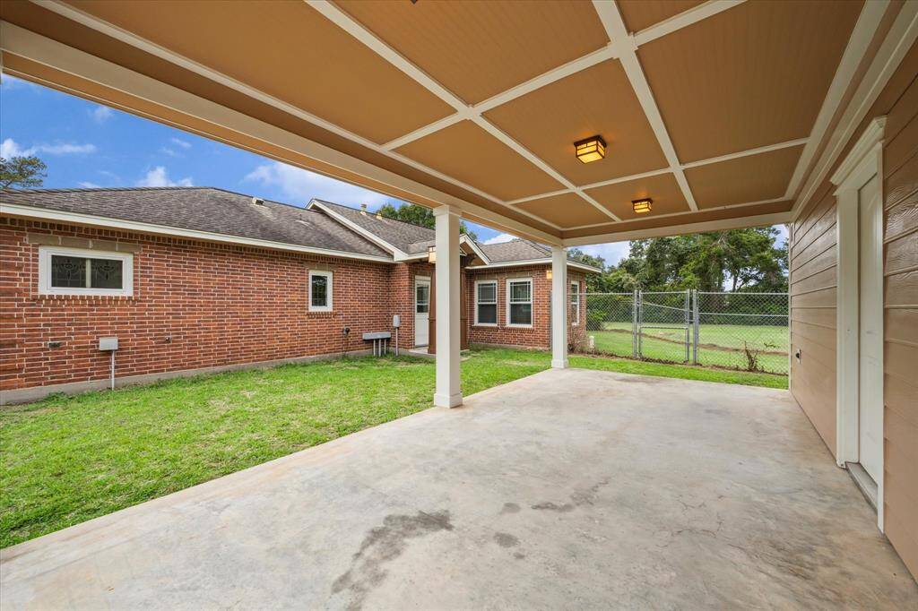 RELAX ON THE COVERED BACK PORCH TO THIS LARGE AIR CONDITIONED WORKSHOP THAT CAN BE USED FOR STORAGE, MAN CAVE, SHE SHED, HOBBY ROOM, GAME ROOM, TOOL SHOP COMPLETE WITH CUSTOM CABINETS