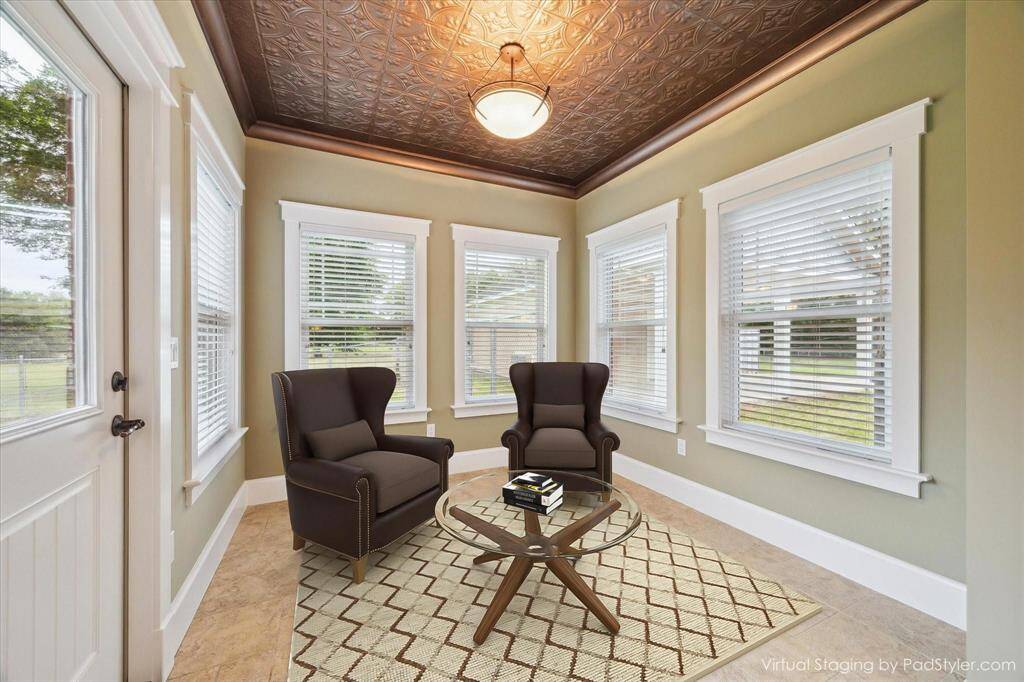 THIS SUNROOM/BREAKFAST AREA IS LUMINOUS BATHED IN NATURAL LIGHT FROM A WALL OF ENERGY-EFFICIENT WINDOWS LINED WITH CUSTOM MOLDING AND ARCHITECTURAL REFINEMENT. THE TIN CEILING HAS A COPPER FINISH ADDING A TOUCH OF LUXURY