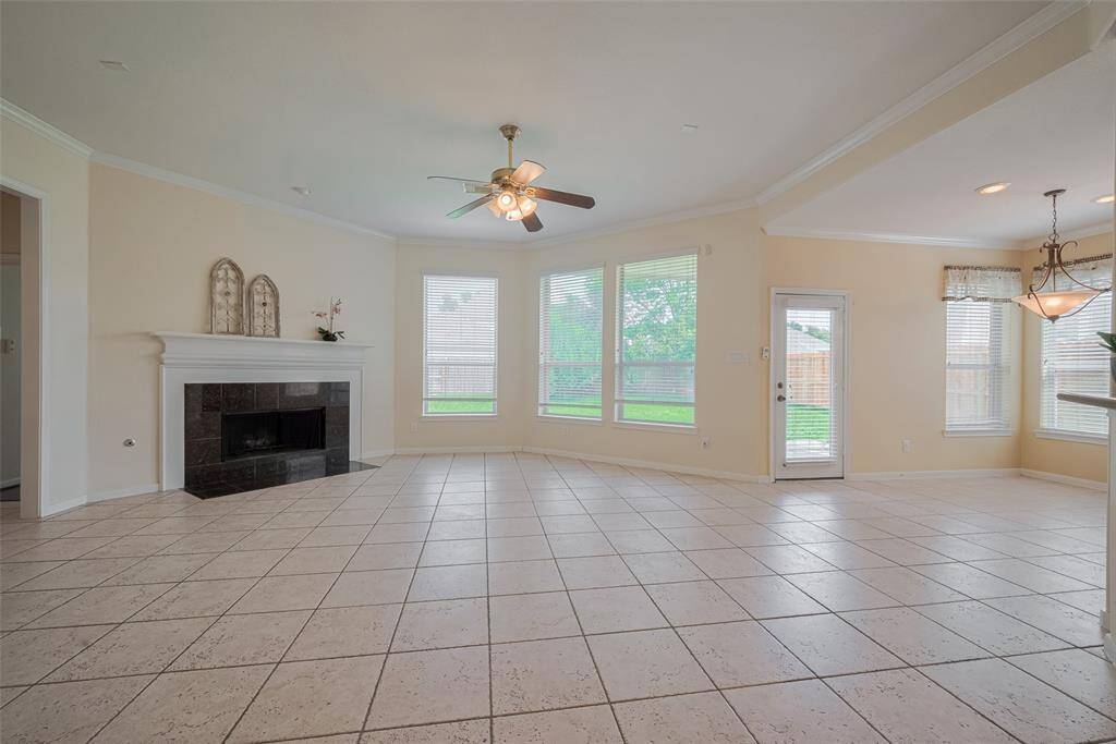 Family with fireplace overlooking the backyard