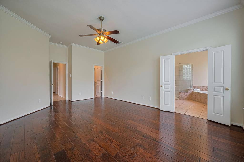 primary bedroom has two walk-in closets, one in the bedroom and the other by the bathroom