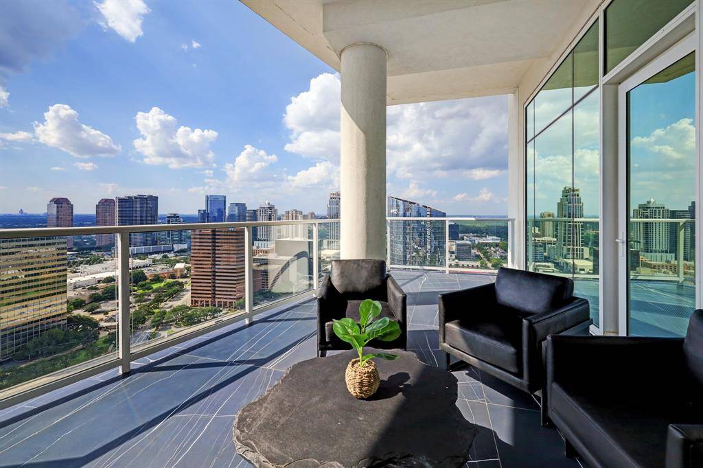 The primary suite enjoys its own private terrace with views west over the Uptown skyline.