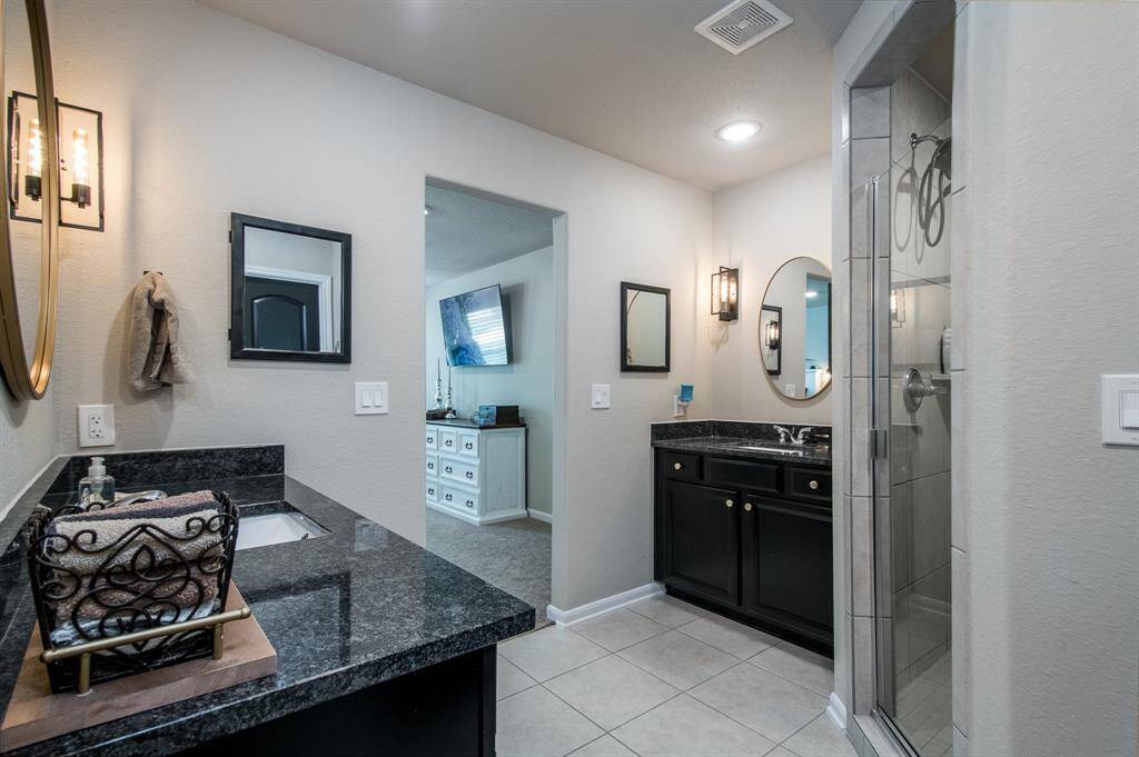 Primary bath with a walk in shower and dual sinks.
