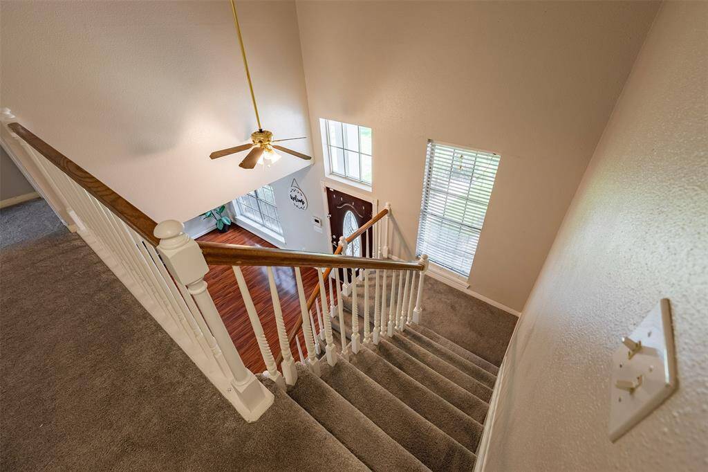 Elegant and airy, the beautiful open staircase leads to the upstairs living area.