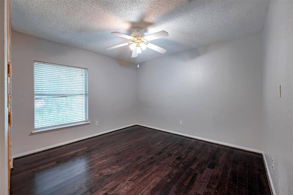 Spacious bedroom with custom closet and ceiling fan for added comfort.