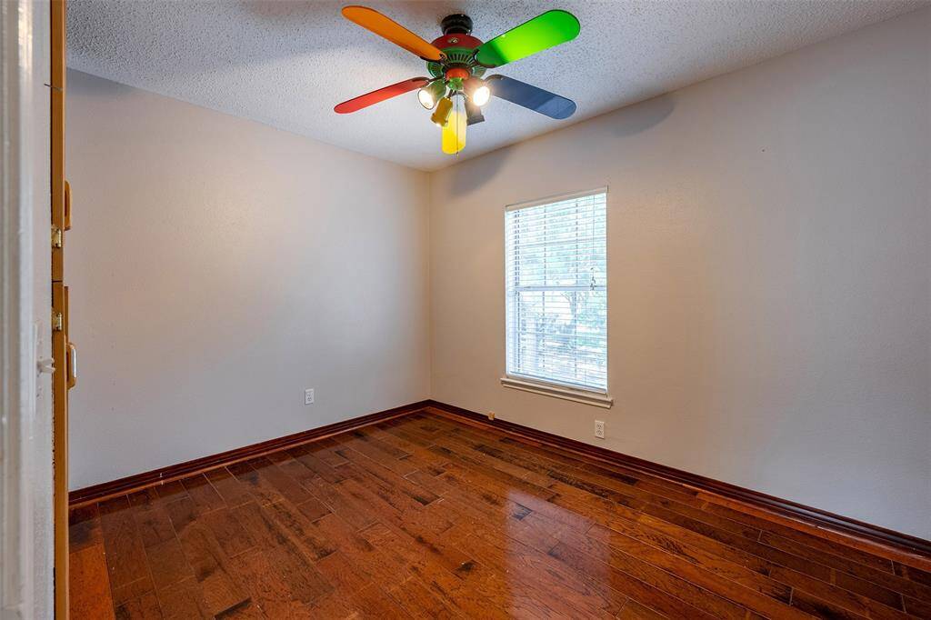 Spacious bedroom with custom closet and ceiling fan for added comfort.